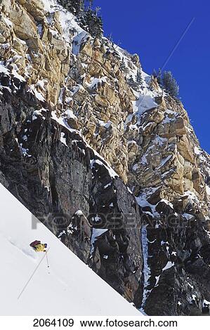 Stock Photo - Young Man Skiing Untracked Slope In The Backcountry Near Alta, Utah, Usa. Fotosearch