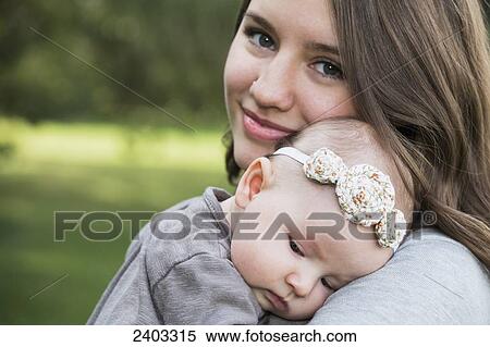 Stock Photography - Young mother with her baby daughter; Edmonton, Alberta, Canada. Fotosearch