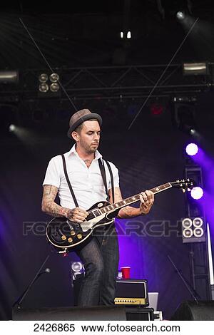 Stock Photography - Young musician playing guitar at a concert; Edmonton, Alberta, Canada. Fotosearch