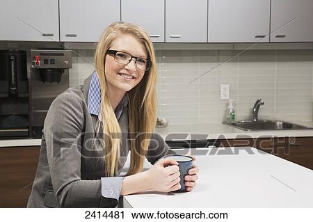 Young office worker at coffee break; Edmonton, Alberta, Canada View Large Photo Image Stock Image - Young office worker at coffee break; Edmonton, Alberta, Canada. Fotosearch