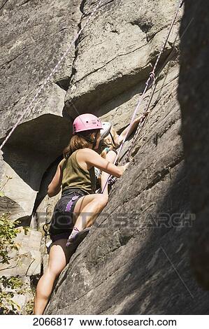 Young Woman Climbing With Daughter (Age 7) Up Granite Cliff At Stone Hills Near Rexford, Montana, Usa View Large Photo Image Stock Photo - Young Woman Climbing With Daughter (Age 7) Up Granite Cliff At Stone Hills Near Rexford, Montana, Usa. Fotosearch