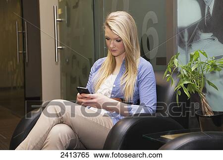 Young woman in a reception area using cell phone while waiting for job interview; Edmonton, Alberta, Canada View Large Photo Image Stock Photography - Young woman in a reception area using cell phone while waiting for job interview; Edmonton, Alberta, Canada. Fotosearch