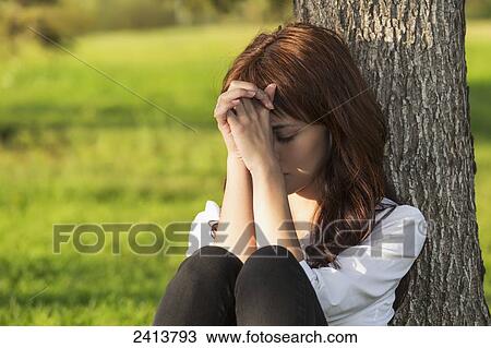 Young woman praying alone in a park; Edmonton, Alberta, Canada View Large Photo Image Stock Image - Young woman praying alone in a park; Edmonton, Alberta, Canada. Fotosearch