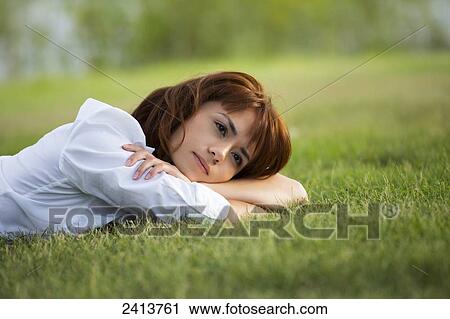 Young woman taking time for herself in a park; Edmonton, Alberta, Canada View Large Photo Image Stock Image - Young woman taking time for herself in a park; Edmonton, Alberta, Canada. Fotosearch