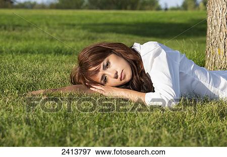 Young woman taking time for herself in a park; Edmonton, Alberta, Canada View Large Photo Image Stock Photo - Young woman taking time for herself in a park; Edmonton, Alberta, Canada. Fotosearch
