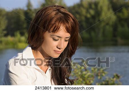 Young woman taking time for herself alone in a park; Edmonton, Alberta, Canada View Large Photo Image Stock Image - Young woman taking time for herself alone in a park; Edmonton, Alberta, Canada. Fotosearch