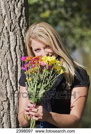 Young woman with a bouquet of flowers; Edmonton, Alberta, Canada View Large Photo Image Stock Photo - Young woman with a bouquet of flowers; Edmonton, Alberta, Canada. Fotosearch