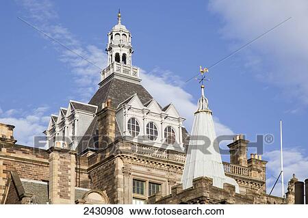 A building with tower on the roof against a blue sky; Edinburgh, Scotland View Large Photo Image Stock Photo - A building with tower on the roof against a blue sky; Edinburgh, Scotland. Fotosearch