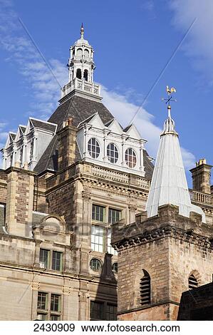 Stock Photo - A building with tower on the roof against a blue sky; Edinburgh, Scotland. Fotosearch