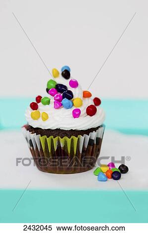 A chocolate cupcake with colorful sprinkles on a cheerful background; Palmer, Alaska, United States of America View Large Photo Image Stock Photography - A chocolate cupcake with colorful sprinkles on a cheerful background; Palmer, Alaska, United States of America. Fotosearch