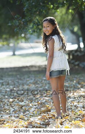A girl walking and playing in autumn leaves; San Francisco, California, United States of America View Large Photo Image Stock Image - A girl walking and playing in autumn leaves; San Francisco, California, United States of America. Fotosearch