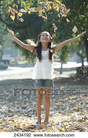 A girl walking and playing in autumn leaves; San Francisco, California, United States of America View Large Photo Image Stock Image - A girl walking and playing in autumn leaves; San Francisco, California, United States of America. Fotosearch