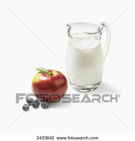 A glass pitcher of milk with an apple and blueberries View Large Photo Image Stock Image - A glass pitcher of milk with an apple and blueberries. Fotosearch