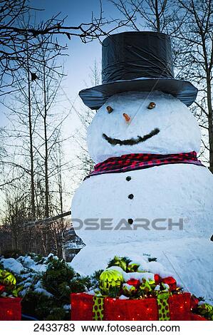 Stock Image - A huge snowman and Christmas gift boxes at Chena Hot Springs Resort; Fairbanks, Alaska, United States of America. Fotosearch