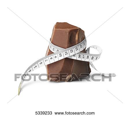 Stock Image - A measuring tape wrapped around a piece of chocolate. Fotosearch