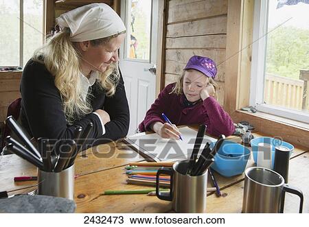 A mother with daughter writing in a tablet at a table in a cabin, Shoup Bay State Marine Park, Prince William Sound; Valdez, Alaska, United States of America View Large Photo Image Stock Image - A mother with daughter writing in a tablet at a table in a cabin, Shoup Bay State Marine Park, Prince William Sound; Valdez, Alaska, United States of America. Fotosearch