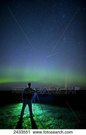 A photographer captures the Northern lights and shooting star, near Edmonton; Alberta Canada View Large Photo Image Stock Image - A photographer captures the Northern lights and shooting star, near Edmonton; Alberta Canada. Fotosearch