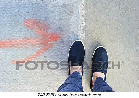 A red arrow spray painted on the concrete pointing to feet; London, England View Large Photo Image Stock Photo - A red arrow spray painted on the concrete pointing to feet; London, England. Fotosearch