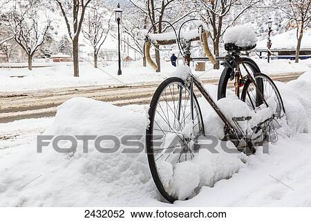 A road bike covered with snow sits by the side of a snowy road waiting for spring; Glenwood Springs, Colorado, United States of America View Large Photo Image Stock Image - A road bike covered with snow sits by the side of a snowy road waiting for spring; Glenwood Springs, Colorado, United States of America. Fotosearch