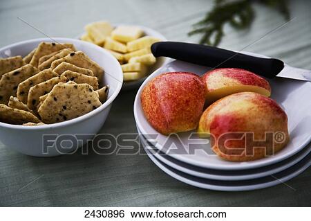 Stock Photograph - A snack of cut apples, crackers and cheese; Abbotsford, British Columbia, Canada. Fotosearch