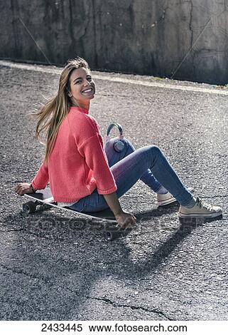 A teenage girl sitting on a skateboard; Tarifa, Cadiz, Andalusia, Spain View Large Photo Image Stock Photography - A teenage girl sitting on a skateboard; Tarifa, Cadiz, Andalusia, Spain. Fotosearch