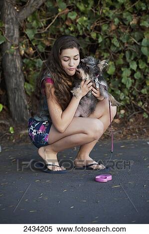 Stock Photography - A teenaged girl out with her dog; San Francisco, California, United States of America. Fotosearch