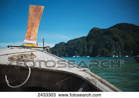 Stock Image - A view from a boat of the coast of the island of Koh Phi Phi in the Andaman Sea; Thailand. Fotosearch