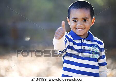 A young boy giving the thumbs up sign; San Francisco, California, United States of America View Large Photo Image Stock Photo - A young boy giving the thumbs up sign; San Francisco, California, United States of America. Fotosearch
