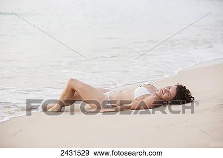 A young woman laying on the beach in the Caribbean; Caribbean View Large Photo Image Stock Photo - A young woman laying on the beach in the Caribbean; Caribbean. Fotosearch