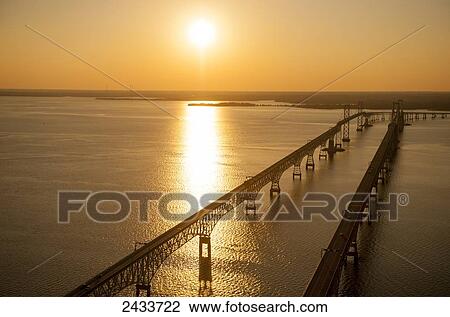 Stock Image - Aerial view of Bay Bridge at sunset over Chesapeake Bay; Maryland, United States of America. Fotosearch