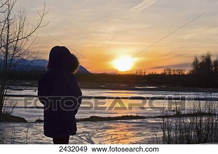 An Alaska native girl enjoying the sunset at Matanuska River in winter; Palmer, Alaska, United States of America View Large Photo Image Stock Photo - An Alaska native girl enjoying the sunset at Matanuska River in winter; Palmer, Alaska, United States of America. Fotosearch
