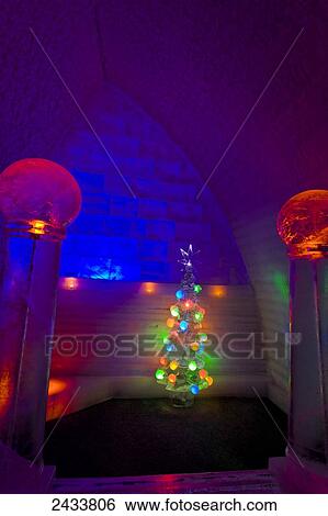 Stock Photograph - An ice carved Christmas tree at the Christmas themed guest room in Aurora Ice Hotel Museum, Chena Hot Springs Resort; Fairbanks, Alaska, United States of America. Fotosearch