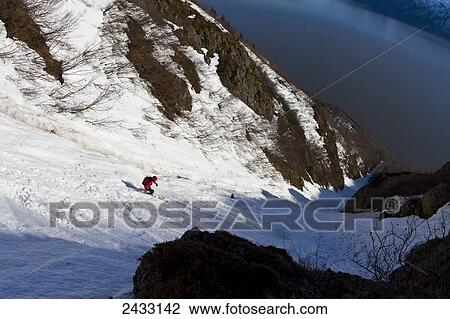 Stock Image - Backcountry skiing above the Seward Highway, Chugach Front Mountains, Southcentral Alaska; Alaska, United States of America. Fotosearch