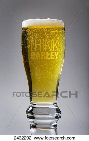 Beer glass full of beer with frothy head and "Think Barley" printed on glass; Calgary, Alberta, Canada View Large Photo Image Stock Image - Beer glass full of beer with frothy head and "Think Barley" printed on glass; Calgary, Alberta, Canada. Fotosearch