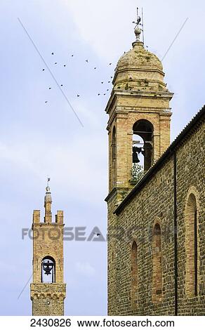 Stock Photograph - Bell towers on a church; Montalcino, Tuscany, Italy. Fotosearch