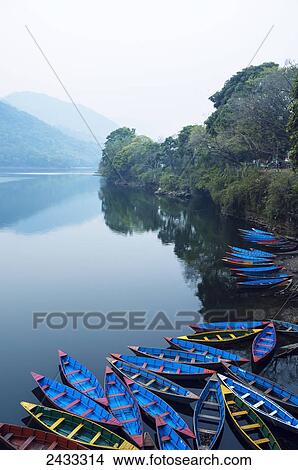 Boats in the famous Pokhara lake; Pokhara, Nepal View Large Photo Image Picture - Boats in the famous Pokhara lake; Pokhara, Nepal. Fotosearch