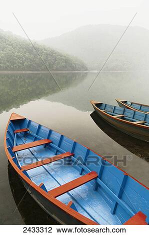 Stock Image - Boats in the famous Pokhara Lake; Pokhara, Nepal. Fotosearch