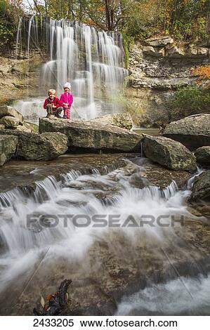 Brother and sister pose in front of a waterfall in Rock Glen Conservation Area; Ontario, Canada View Large Photo Image Stock Photography - Brother and sister pose in front of a waterfall in Rock Glen Conservation Area; Ontario, Canada. Fotosearch