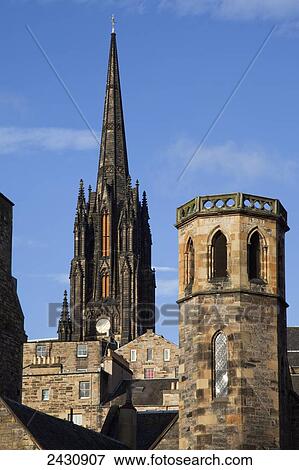 Clock tower of a cathedral and rooftops of various buildings against a blue sky; Edinburgh, Scotland View Large Photo Image Stock Photo - Clock tower of a cathedral and rooftops of various buildings against a blue sky; Edinburgh, Scotland. Fotosearch