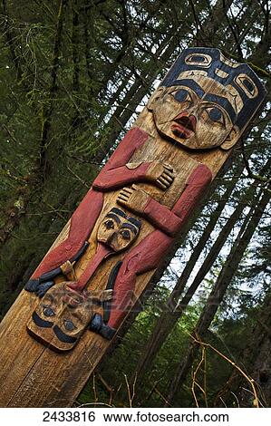 Stock Photograph - Close up of a totem pole at the Totem Trail, Sitka National Historical Park; Sitka, Alaska, United States of America. Fotosearch