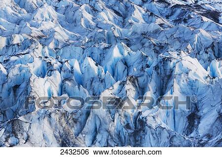Stock Photograph - Close up of Shoup glacier showing ice with traces of glacial silt and dirt on it, Shoup Bay State Marine Park, Prince William Sound; Valdez, Alaska, United States of America. Fotosearch