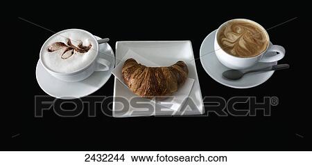 Picture - Coffee and croissant on a black background. Fotosearch