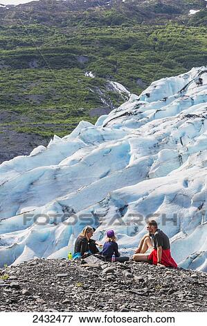 Couple with daughter having a snack overlooking a glacier, Shoup Bay State Marine Park, Prince William Sound; Valdez, Alaska, United States of America View Large Photo Image Stock Photo - Couple with daughter having a snack overlooking a glacier, Shoup Bay State Marine Park, Prince William Sound; Valdez, Alaska, United States of America. Fotosearch