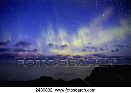 Stock Image - Dramatic scene of the northern lights showing the Atlantic Ocean off the coast of Iceland; Iceland. Fotosearch
