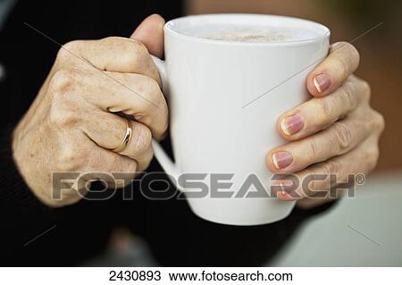 Stock Image - Enjoying a cup of coffee; Abbotsford, British Columbia, Canada. Fotosearch