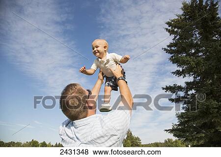 Father throwing toddler son in the air; Edmonton, Alberta, Canada View Large Photo Image Stock Photo - Father throwing toddler son in the air; Edmonton, Alberta, Canada. Fotosearch