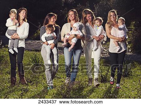 Stock Photo - Five mothers holding baby daughters; Tarifa, Cadiz, Andalusia, Spain. Fotosearch