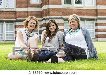 Stock Image - Friends hanging out in a school yard; Edmonton, Alberta, Canada. Fotosearch