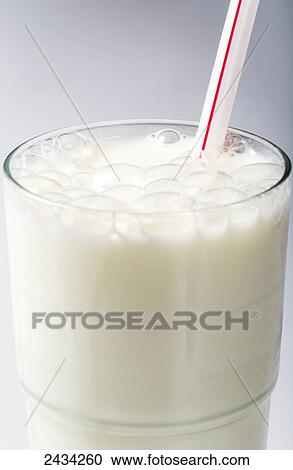 Glass of milk with bubbles and red striped straw on white background; Calgary, Alberta, Canada View Large Photo Image Stock Image - Glass of milk with bubbles and red striped straw on white background; Calgary, Alberta, Canada. Fotosearch