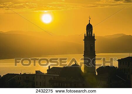 Golden sky at dusk with tower of church; San Lorenzo della Costa, Liguria, Italy View Large Photo Image Stock Photography - Golden sky at dusk with tower of church; San Lorenzo della Costa, Liguria, Italy. Fotosearch